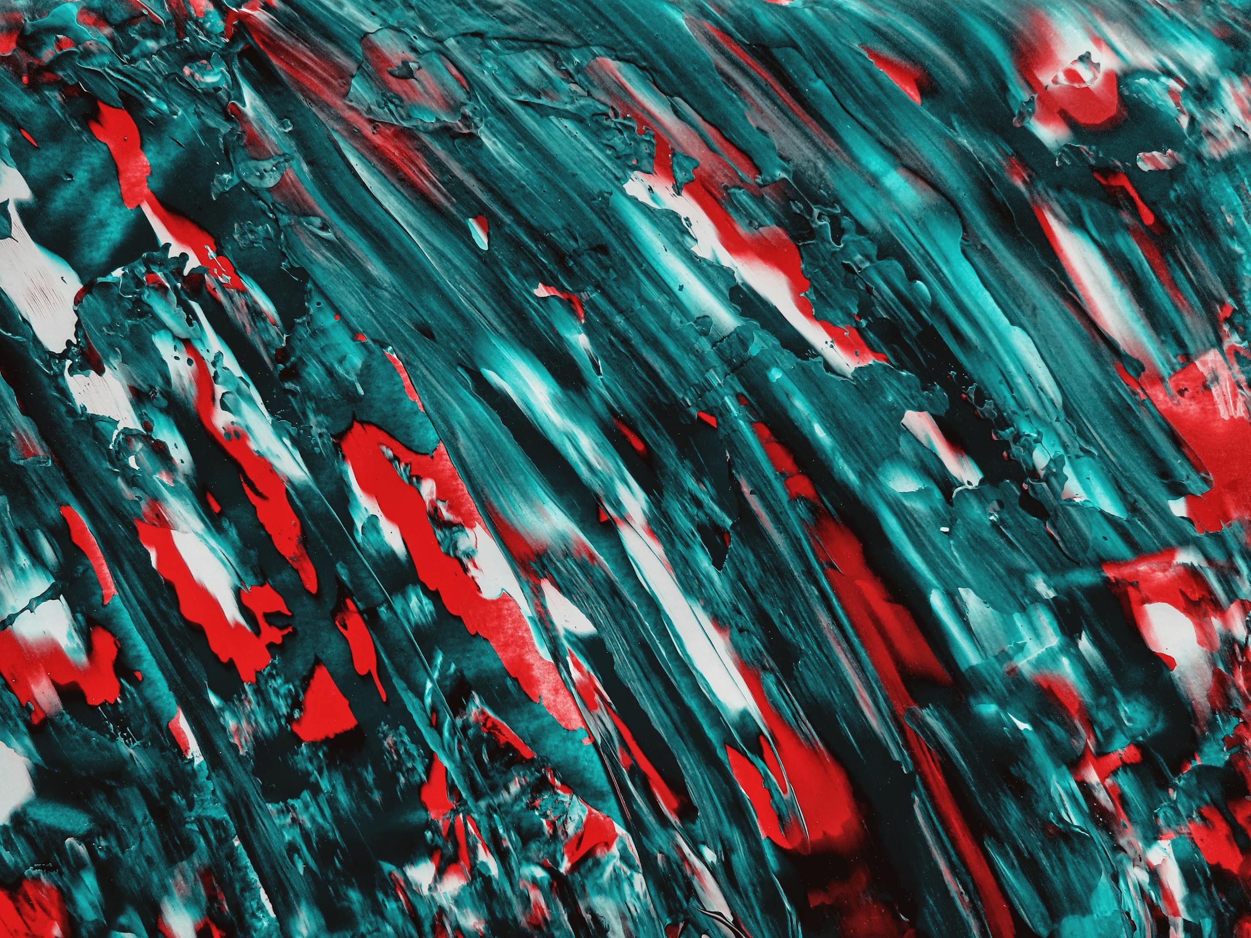 Dynamic red and teal abstract paint swirl texture, perfect for creative design backdrops.