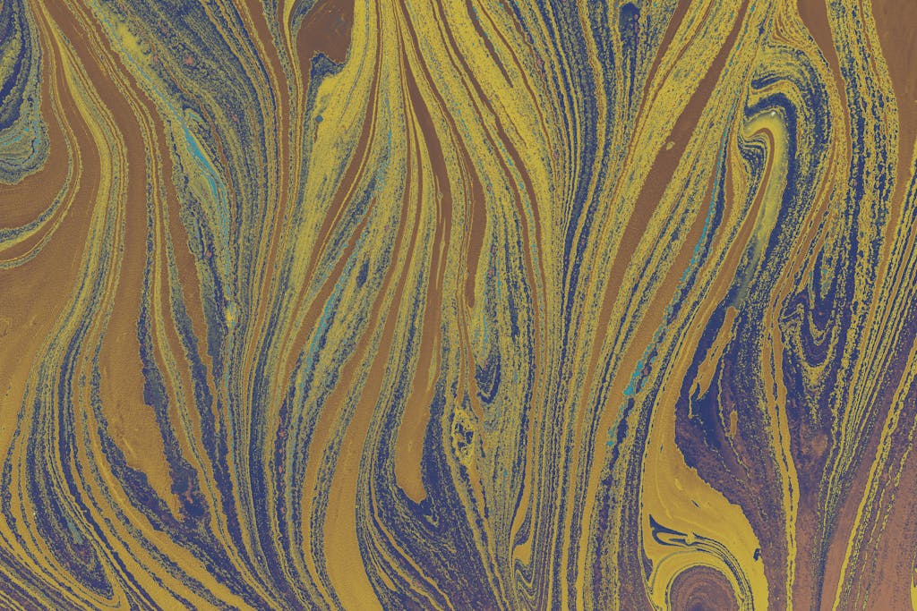 Colorful marbled patterns in blue and gold create eye-catching abstract art.